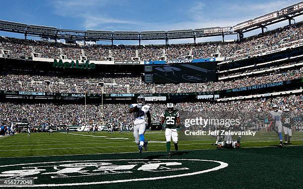 Jeremy Ross of the Detroit Lions scores a 59-yard touchdown in the in the second quarter as Calvin Pryor of the New York Jets looks on at MetLife...