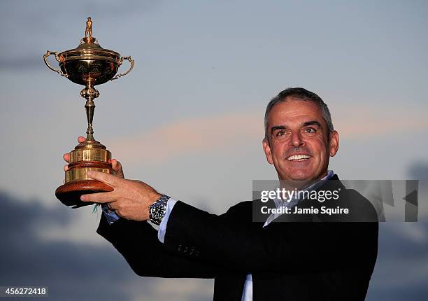 Europe team captain Paul McGinley lifts the Ryder Cup trophy after the Singles Matches of the 2014 Ryder Cup on the PGA Centenary course at the...