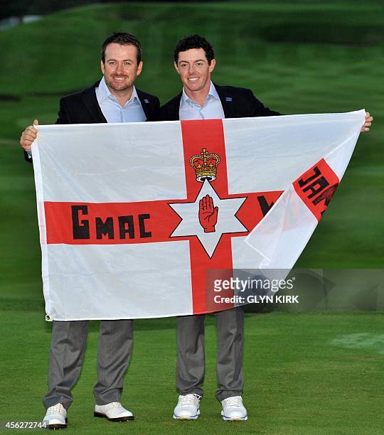 Graeme McDowell of Northern Ireland and compatriot Rory McIlroy pose for photographs after Team Europe retained the Ryder Cup on the final day of the...