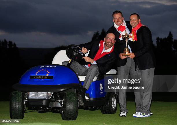 Thomas Bjorn, Ian Poulter and Sergio Garcia of Europe pose with the Ryder Cup trophy after the Singles Matches of the 2014 Ryder Cup on the PGA...