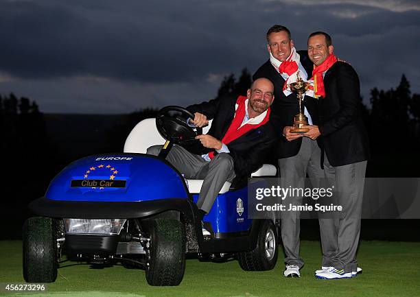 Thomas Bjorn, Ian Poulter and Sergio Garcia of Europe pose with the Ryder Cup trophy after the Singles Matches of the 2014 Ryder Cup on the PGA...