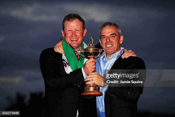 Jamie Donaldson and Europe team captain Paul McGinley pose with the Ryder Cup trophy after the Singles Matches of the 2014 Ryder Cup on the PGA...