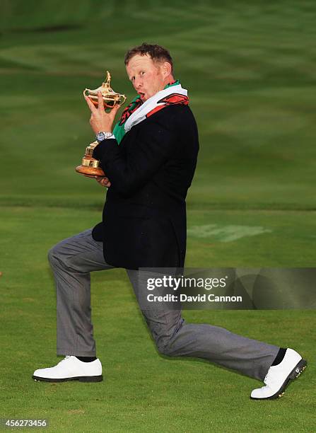 Jamie Donaldson of Europe poses with the Ryder Cup trophy after the Singles Matches of the 2014 Ryder Cup on the PGA Centenary course at the...