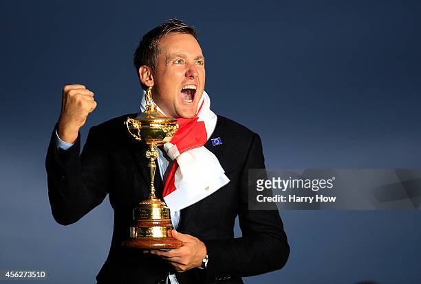 Ian Poulter of Europe poses with the Ryder Cup trophy after the Singles Matches of the 2014 Ryder Cup on the PGA Centenary course at the Gleneagles...