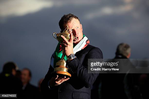 Jamie Donaldson of Europe poses with the Ryder Cup trophy after the Singles Matches of the 2014 Ryder Cup on the PGA Centenary course at the...