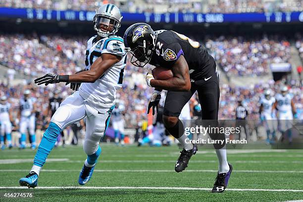 Wide receiver Torrey Smith of the Baltimore Ravens scores a third quarter touchdown against the Carolina Panthers at M&T Bank Stadium on September...