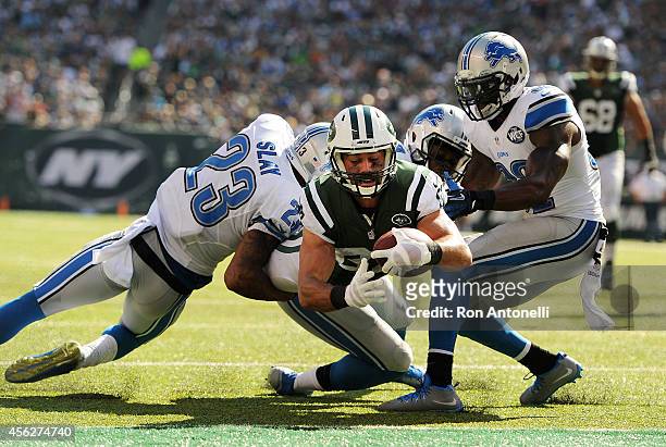Eric Decker of the New York Jets scores a touchdown in the third quarter against the defense of Darius Slay of the Detroit Lions at MetLife Stadium...