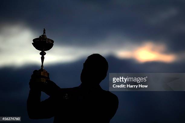 Europe team captain Paul McGinley poses with the Ryder Cup trophy after the Singles Matches of the 2014 Ryder Cup on the PGA Centenary course at the...