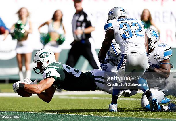 Eric Decker of the New York Jets scores a touchdown in the third quarter against the defense of Darius Slay and James Ihedigbo of the Detroit Lions...