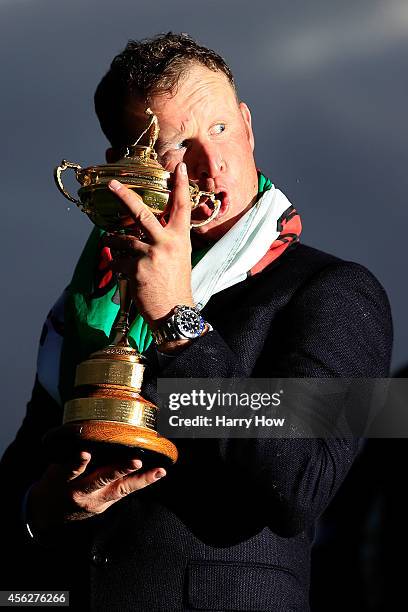 Jamie Donaldson of Europe poses with the Ryder Cup trophy after the Singles Matches of the 2014 Ryder Cup on the PGA Centenary course at the...