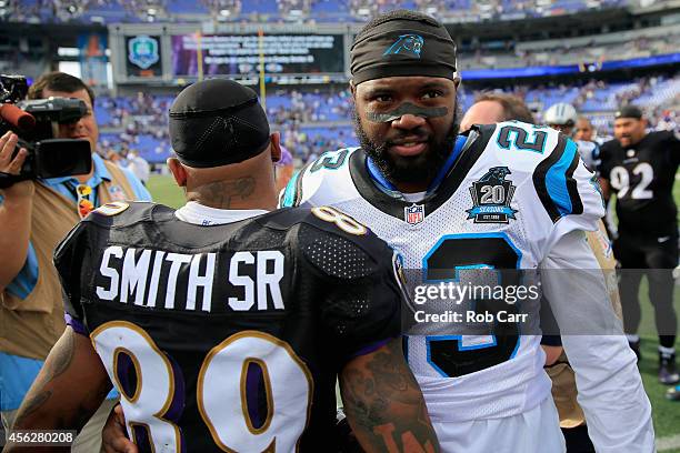 Wide receiver Steve Smith of the Baltimore Ravens and cornerback Melvin White of the Carolina Panthers meet at mid field after the Ravens defeated...