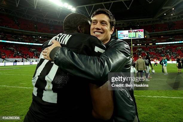 Presenter Vernon Kay hugs Menelik Watson of the Oakland Raiders following the NFL match between the Oakland Raiders and the Miami Dolphins at Wembley...