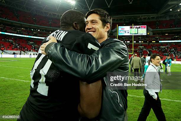 Presenter Vernon Kay hugs Menelik Watson of the Oakland Raiders following the NFL match between the Oakland Raiders and the Miami Dolphins at Wembley...