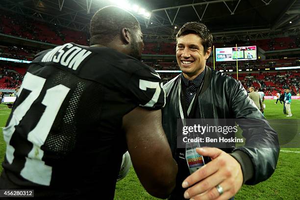 Presenter Vernon Kay hugs Menelik Watson of the Oakland Raiders following the NFL match between the Oakland Raiders and the Miami Dolphins at Wembley...