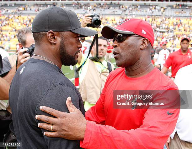 Head coach Mike Tomlin of the Pittsburgh Steelers talks with head coach Lovie Smith of the Tampa Bay Buccaneers after Tampa Bay's 27-24 win at Heinz...