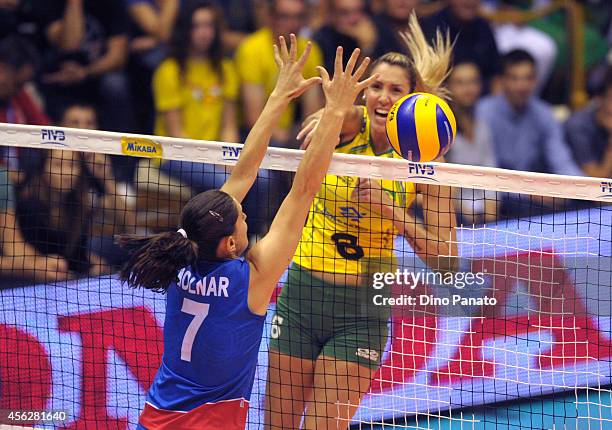 Thaisa Menezes of Brazil spikes the ball against Brizitka Molnar of Serbia during the FIVB Women's World Championship pool Brankica Mihajlovic of...