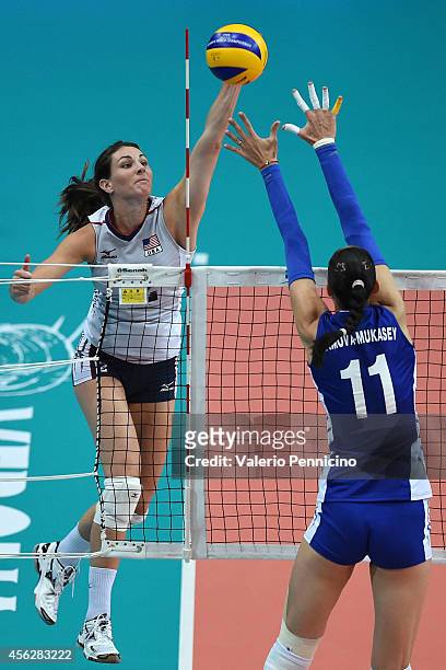 Kelly Murphy of USA spikes as Ekaterina Gamova of Russia blocks during the FIVB Women's World Championship pool C match between USA and Russia on...