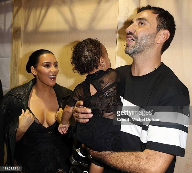 Kim Kardashian, North West and designer Ricardo Tisci attend the Givenchy show as part of the Paris Fashion Week Womenswear Spring/Summer 2015 on...