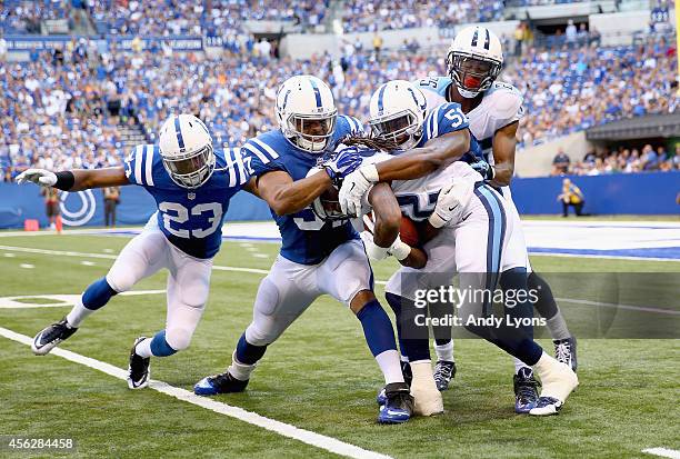 Loucheiz Purifoy,Josh Mcnary and Henoc Muamba of the Indianapolis Colts tackle Dexter Mccluster of the Tennessee Titans during the game at Lucas Oil...