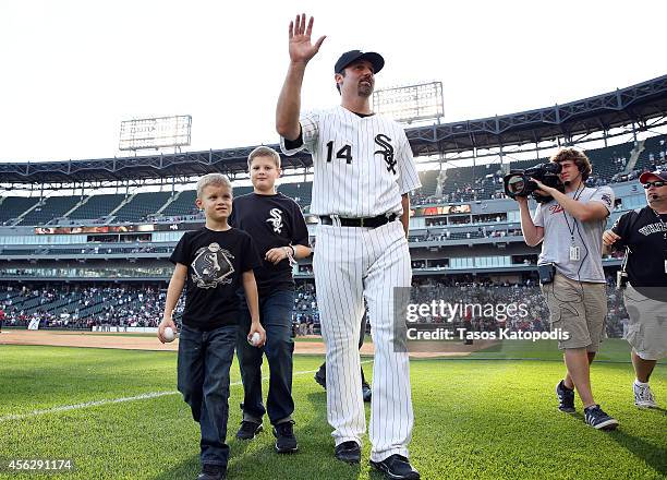 Paul Konerko of the Chicago White Sox walks the field with his sons for the last time at the end of play against the Kansas City Royals on September...