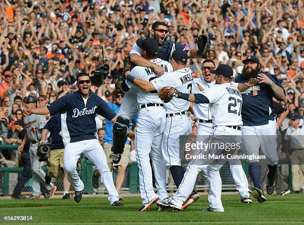 Alex Avila of the Detroit Tigers jumps into the arms of Joe Nathan after the victory against the Minnesota Twins to clinch the American League...
