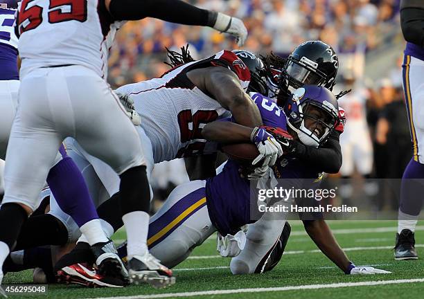 Cliff Matthews and Kemal Ishmael of the Atlanta Falcons tackle Teddy Bridgewater of the Minnesota Vikings during the fourth quarter of the game on...