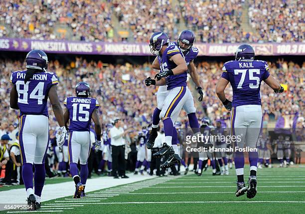 Rhett Ellison and Bear Pascoe of the Minnesota Vikings celebrate after Ellison completed a two-point conversion against the Atlanta Falcons during...
