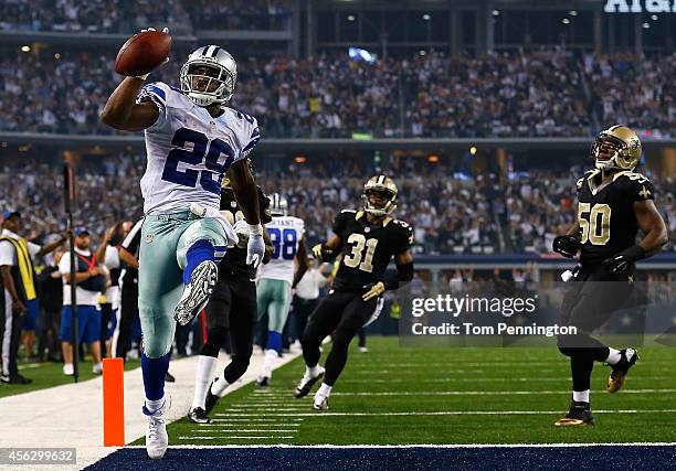 DeMarco Murray of the Dallas Cowboys runs for a touchdown against the New Orleans Saints in the first half at AT&T Stadium on September 28, 2014 in...