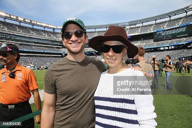 Evan Jonigkeit and Zosia Mamet attend the Detroit Lions vs New York Jets Game at MetLife Stadium on September 28, 2014 in East Rutherford, New Jersey.