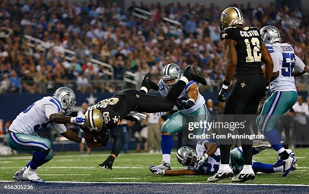 Jimmy Graham of the New Orleans Saints scores a touchdown as Rolando McClain of the Dallas Cowboys tries to make the stop in the second half at AT&T...