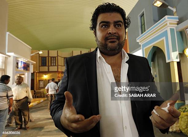 Director Ali al-Qassem talks to a reporter on the set of the television series, whose title is loosely translated as "State of Superstition", during...