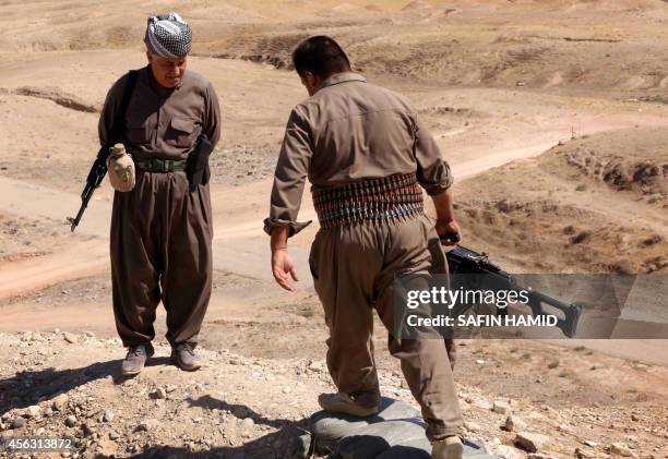 Peshmerga fighters take position at a post in the strategic Jalawla area, in Diyala province, which is a gateway to Baghdad, as battles with Islamic...