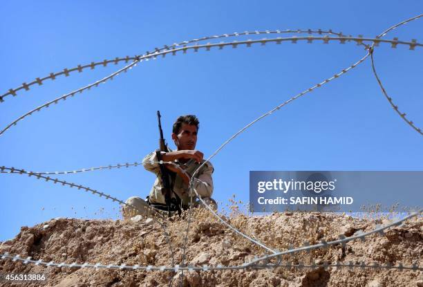 Peshmerga fighter holds a position at a post in the strategic Jalawla area, in Diyala province, which is a gateway to Baghdad, as battles with...