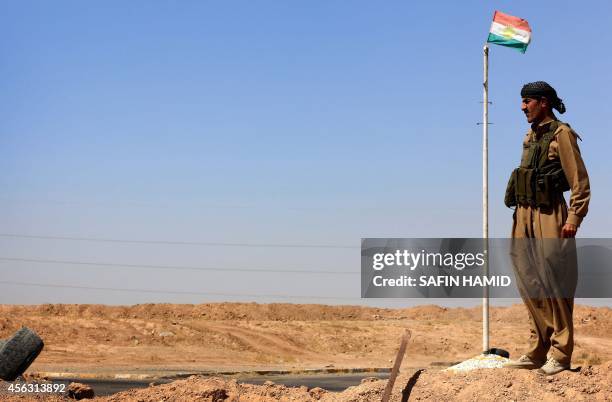 Peshmerga fighter holds a position at a post in the strategic Jalawla area, in Diyala province, which is a gateway to Baghdad, as battles with...