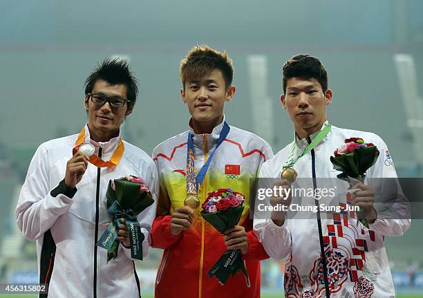 Silver medalist Daichi Sawano of Japan, gold medalist Xue Changrui of China and bronze medalist Sin Minsub of South Korea celebrate on the podium...