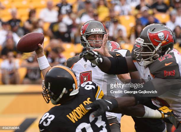 Quarterback Mike Glennon of the Tampa Bay Buccaneers passes as offensive lineman Demar Dotson blocks linebacker Jason Worilds of the Pittsburgh...