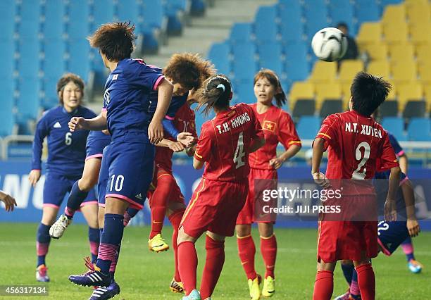 Japan's defender Kana Osafune heads the ball into goal against Vietnam during the women's football semi final at the 2014 Asian Games in Incheon on...