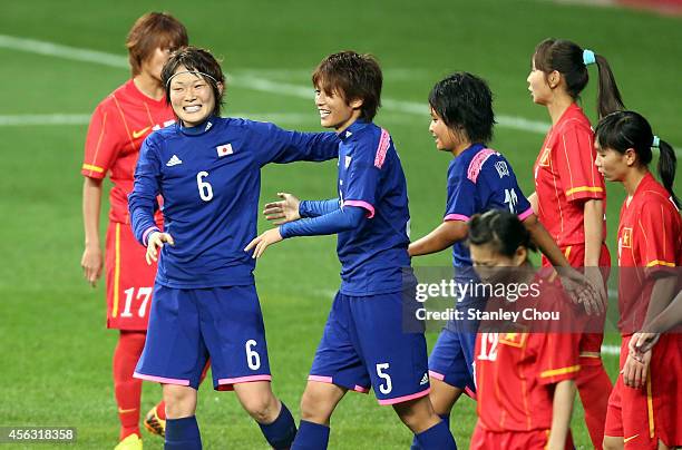 Kana Osafune#5 of Japan celebrates with Mizuho Sakaguchi after scoring against Vietnam during the Women's Football Semi-Final match bewteen Vietnam...