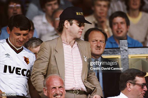 Watford chairman Elton John and manager Graham Taylor take their seats prior to a match at Vicarage Road, circa 1984 in Watford, England.