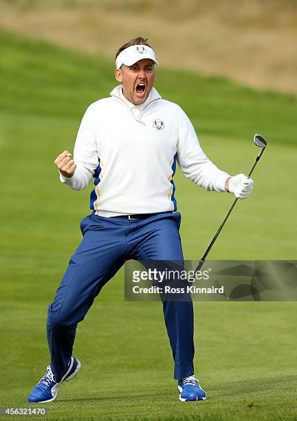 Ian Poulter of Europe celebrates chipping in on the 15th hole during the Morning Fourballs of the 2014 Ryder Cup on the PGA Centenary course at the...