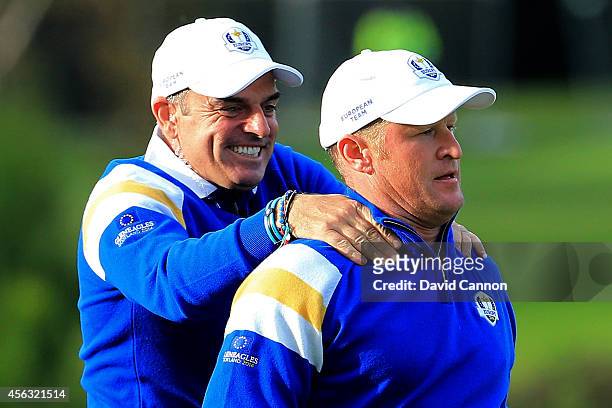 Jamie Donaldson of Europe is congratulated by Europe team captain Paul McGinley on the 15th hole shortly before Europe won the Ryder Cup after...