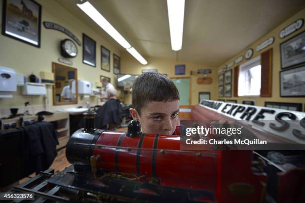 Young boy inspects some of the model trains on display inside the Headhunters Barber Shop and Railway Museum on September 29, 2014 in Enniskillen,...