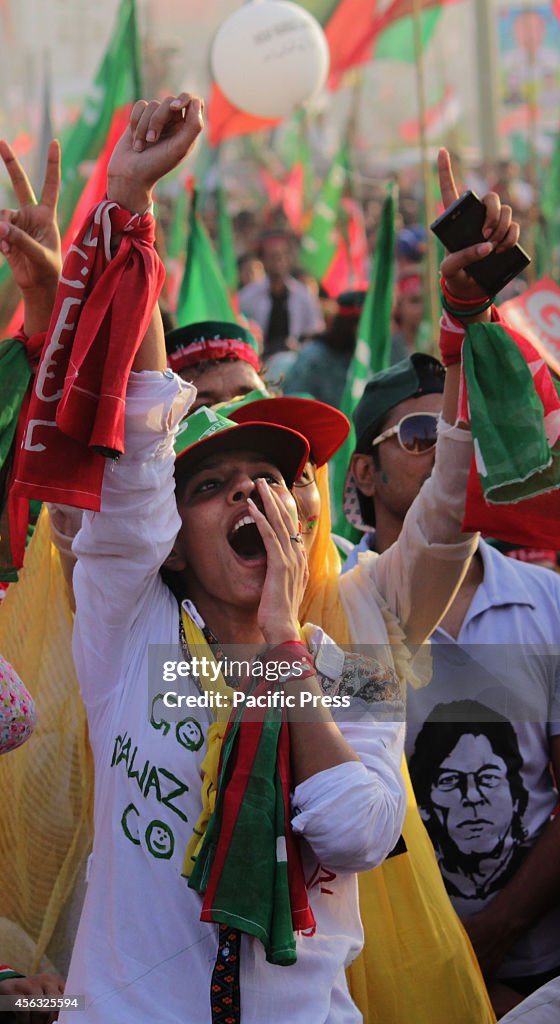 Thousand of  Imran Khan's supporters  wave their hands and...