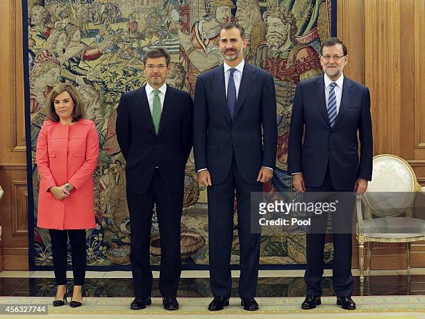 King Felipe of Spain poses with newly appointed Spanish Justice Minister Rafael Catala , Deputy Prime Minister and government spokeswoman Soraya...