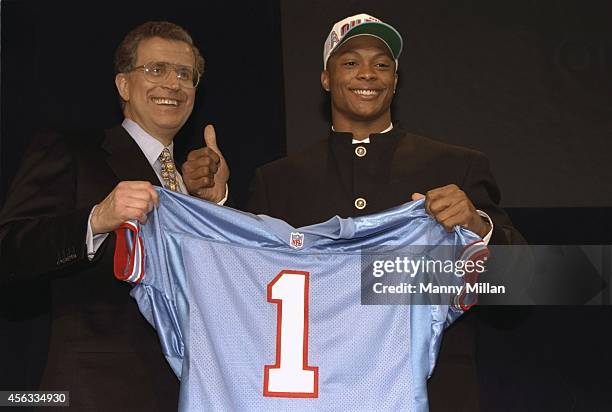 Closeup of Houston Oilers running back and No 14 overall pick Eddie George victorious on stage with NFL commissioner Paul Tagliabue during selection...