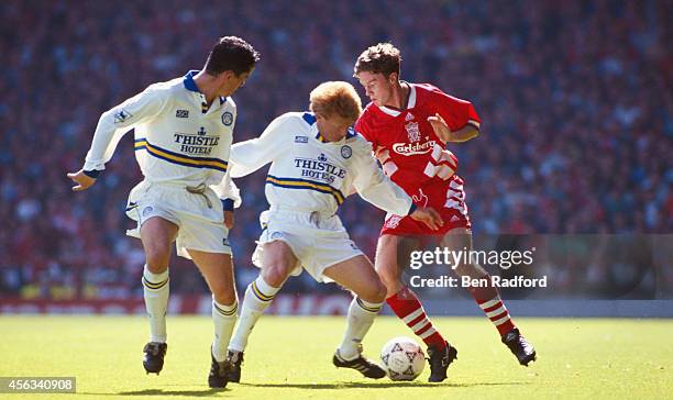 Leeds defenders Gary Kelly and Gordon Strachan attempt to halt Liverpool player Steve McManaman during a Premier League match between Liverpool and...