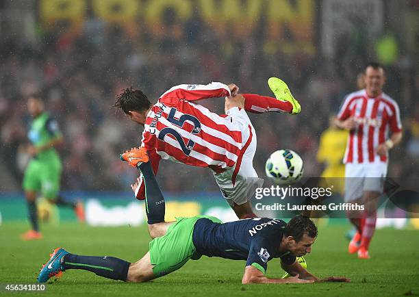 Peter Crouch of Stoke City is challenged by Michael Williamson of Newcastle United during the Barclays Premier League match between Stoke City and...