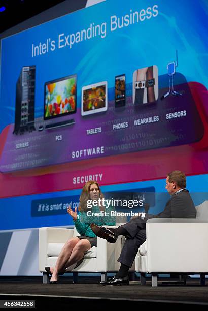 Kim Stevenson, chief information officer of Intel Corp., left, speaks as Mark Hurd, chief executive officer of Oracle Corp., listens during the...