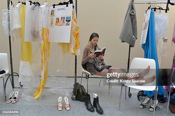 Model is seen reading backstage prior the Emanuel Ungaro show as part of Paris Fashion Week Womenswear Spring/Summer 2015 on September 29, 2014 in...