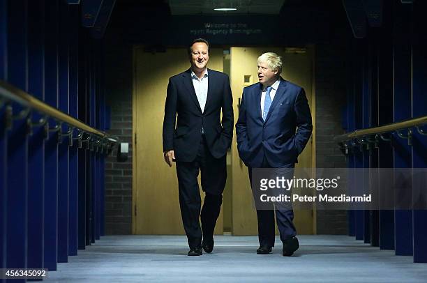 Prime Minister David Cameron walks with Mayor of London and Parliamentary candidate Boris Johnson at the Conservative party conference on September...